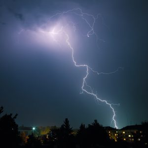 Lightning over the city. Powerfull flash at night