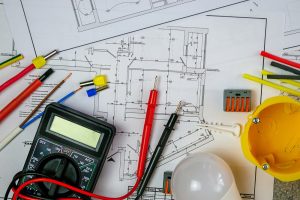 Flat lay composition with electrician's tools on house plan. Space for text.Selective focus.